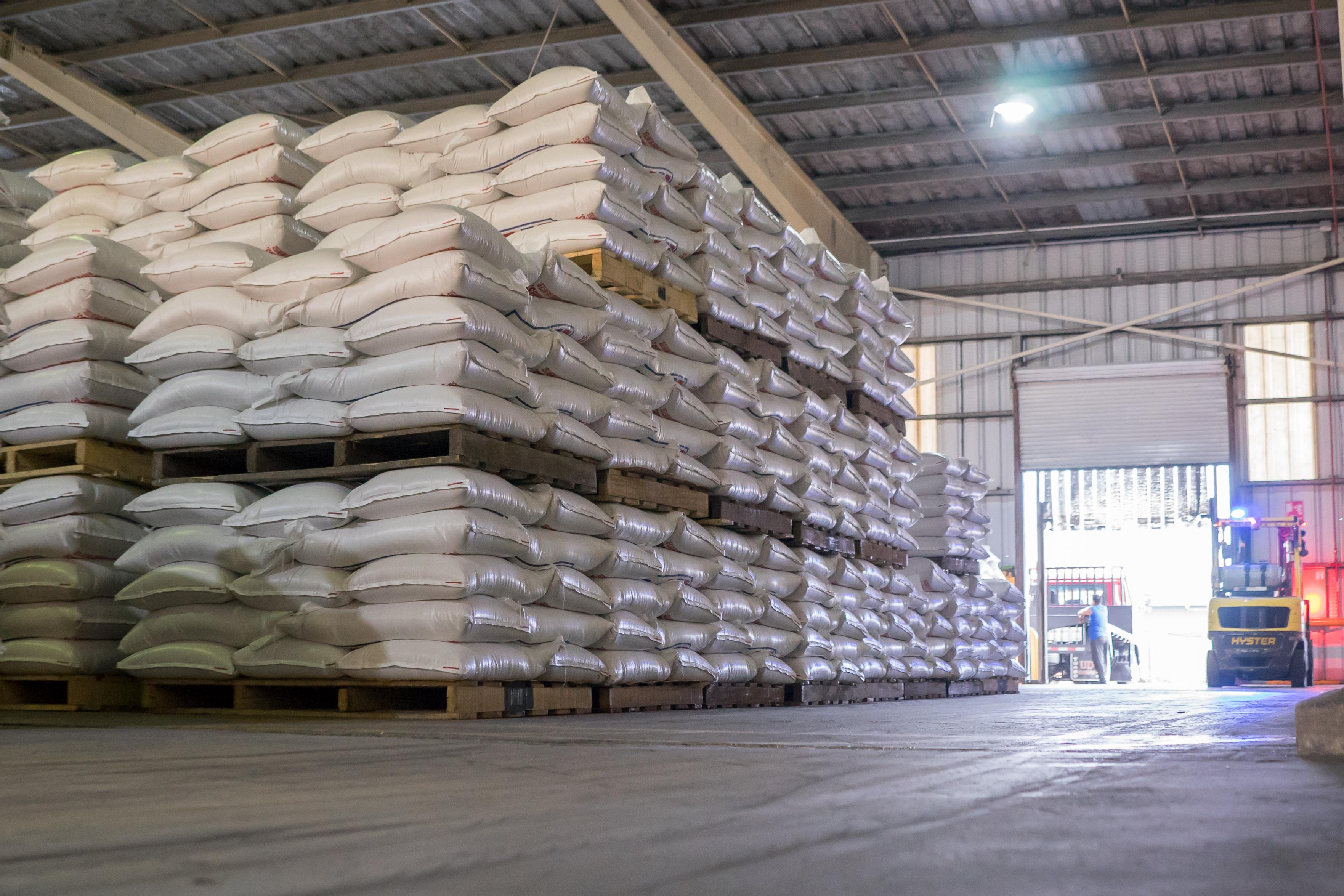 Bagged animal feed stacked on pallets inside a feed warehouse